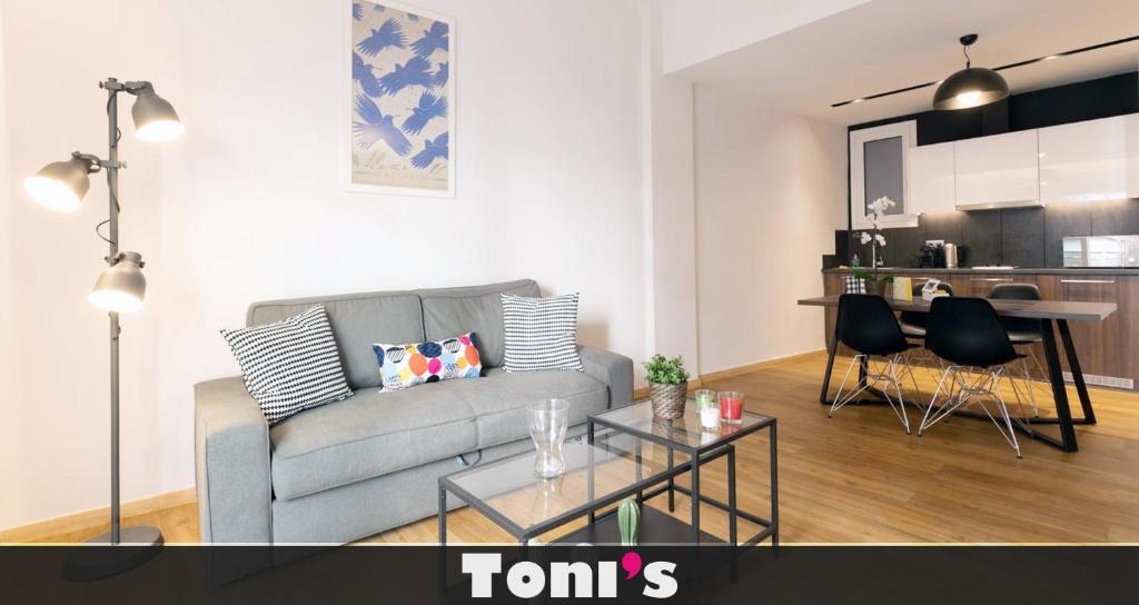 a living room with a couch and a table at TONI'S Cute 2BD Apartment in Koukaki! in Athens