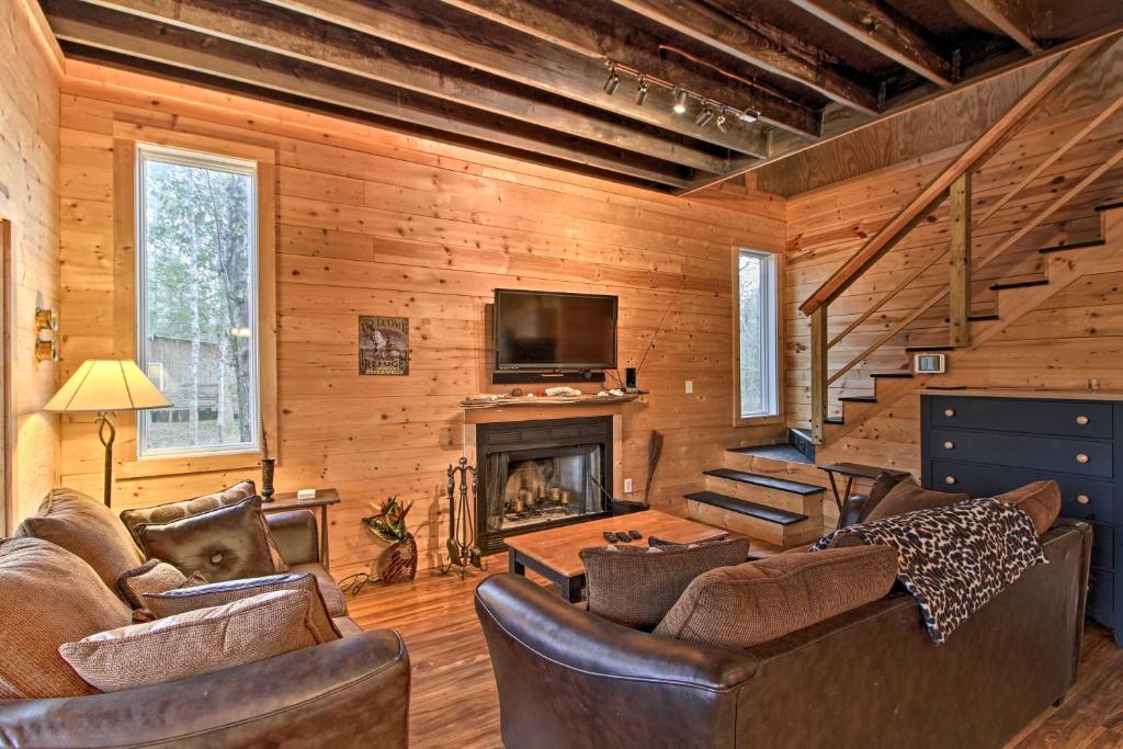 a living room with leather furniture and a fireplace at Pet-Friendly Santee River Retreat with Private Dock! in Georgetown
