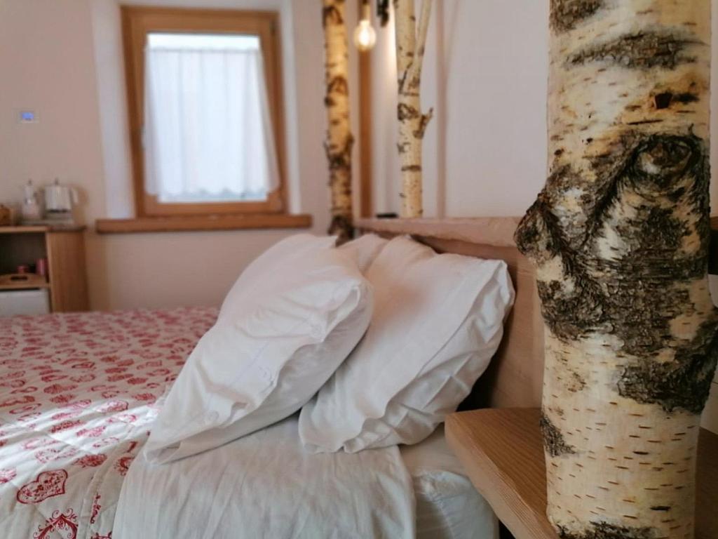 Postel nebo postele na pokoji v ubytování Ai Larici