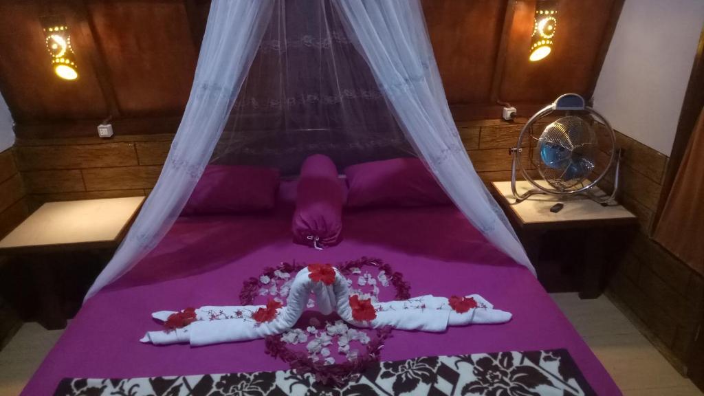 Postel nebo postele na pokoji v ubytování Orangutan Bungalow