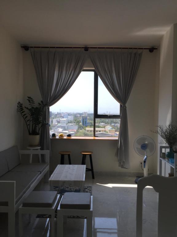 salon z dużym oknem i kanapą w obiekcie JACY Apartment - Phan Rang, Ninh Thuan w mieście Phan Rang-Tháp Chàm