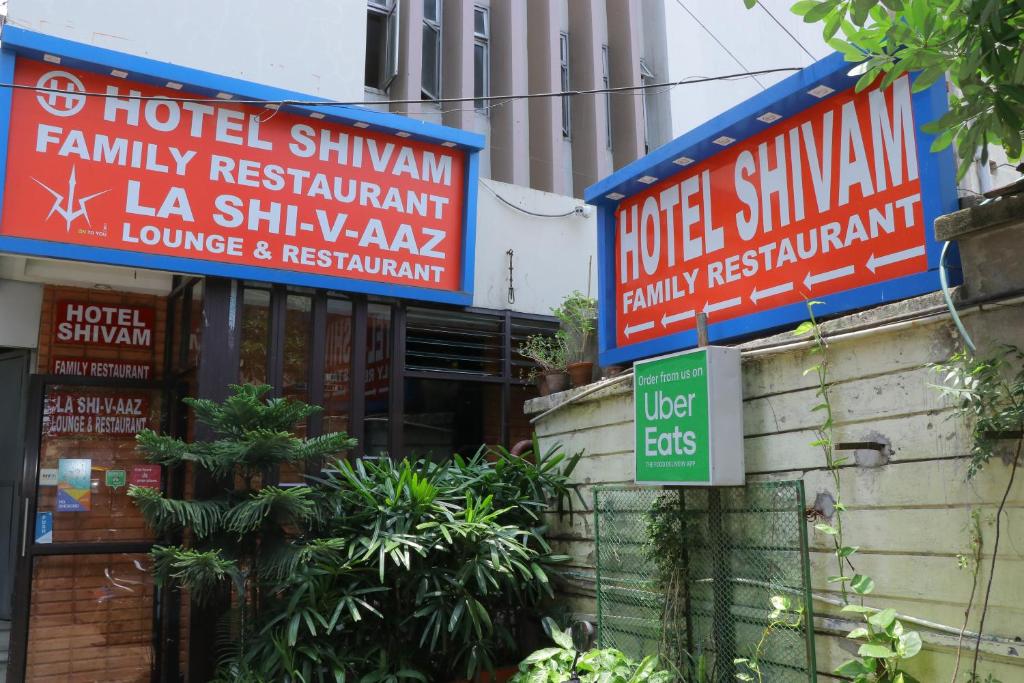 a group of signs on the side of a building at HOTEL SHIVAM in Howrah
