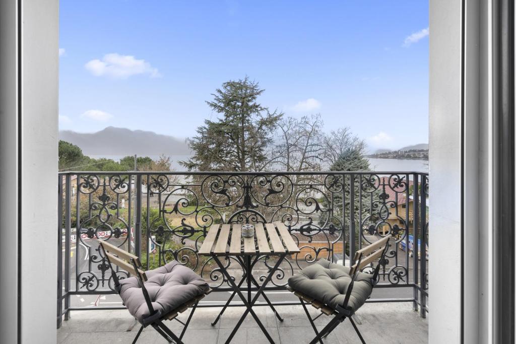 蒙特勒Montreux Grand Rue - Swiss Hotel Apartments的阳台上的一张桌子和两把椅子