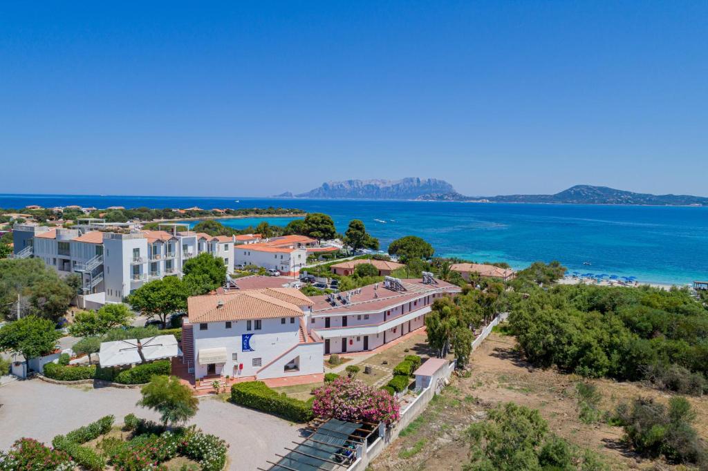a house with a view of the ocean and mountains at Hotel Mare Blue in Olbia