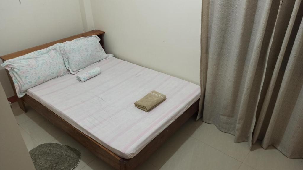 a small bed in a bedroom with a pillow on it at MC TOWN CENTRE in Romblon