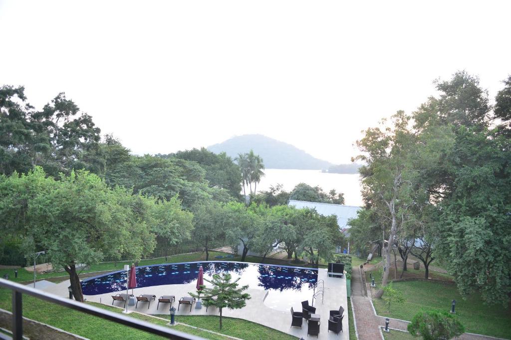 a view of a park with a table and chairs at Agbo Hotel in Polonnaruwa