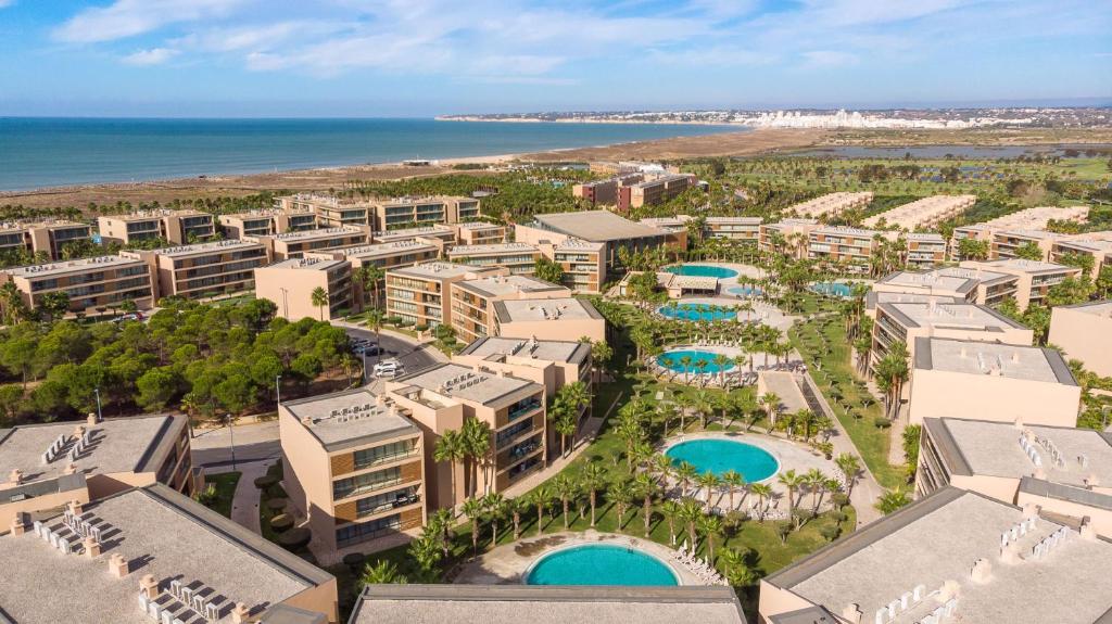 an aerial view of the resort with the ocean in the background at Herdade dos Salgados Vila das Lagoas in Albufeira