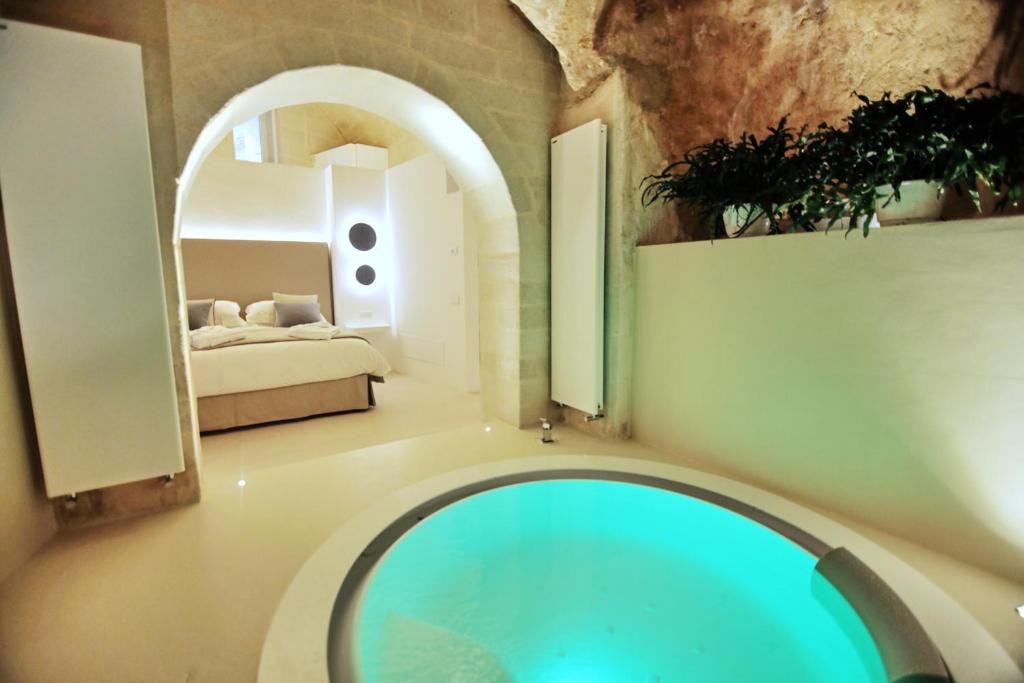 a room with a swimming pool and a bedroom at Anima Pietra Luxury Suite in Matera