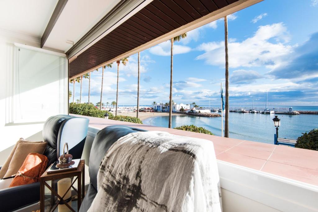a balcony with a view of the water at Beach Front Apartment-1st Line in Marbella