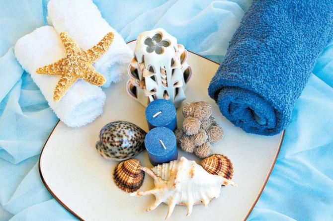 a board with shells and a towel and a starfish at Casa SERGIO Budva Rooms & Apartments in Budva
