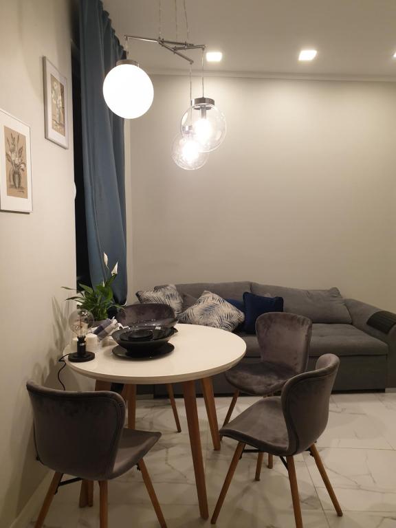 a living room with a table and a couch at Centr Majori Home Apartament in Jūrmala