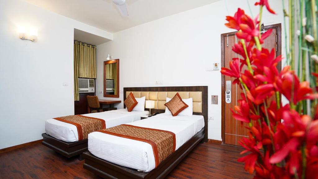 Postel nebo postele na pokoji v ubytování Hotel Pooja Palace