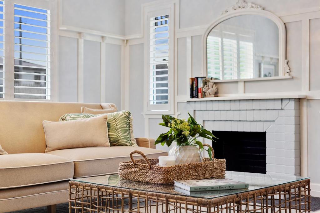 a living room with a couch and a fireplace at Nell's Place in Toowoomba