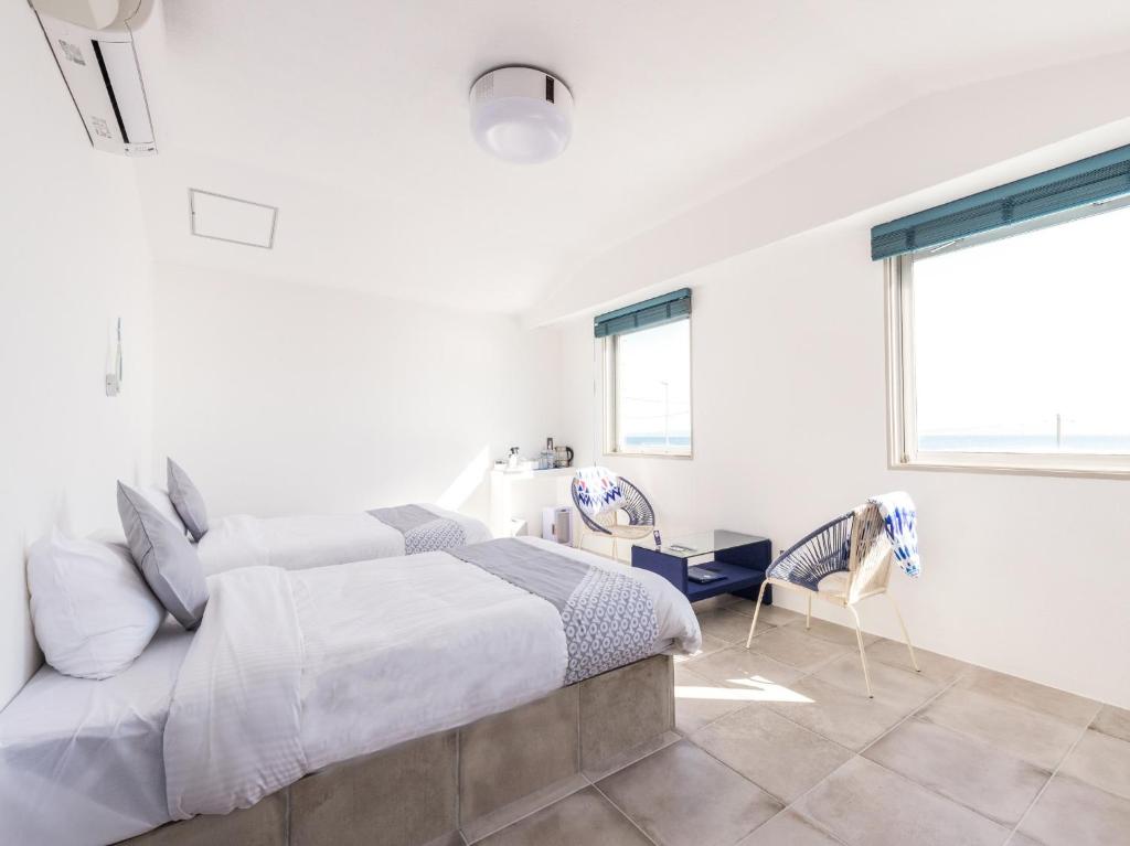 a white bedroom with a bed and a window at Mykonos Resort Miura / Vacation STAY 62210 in Yokosuka