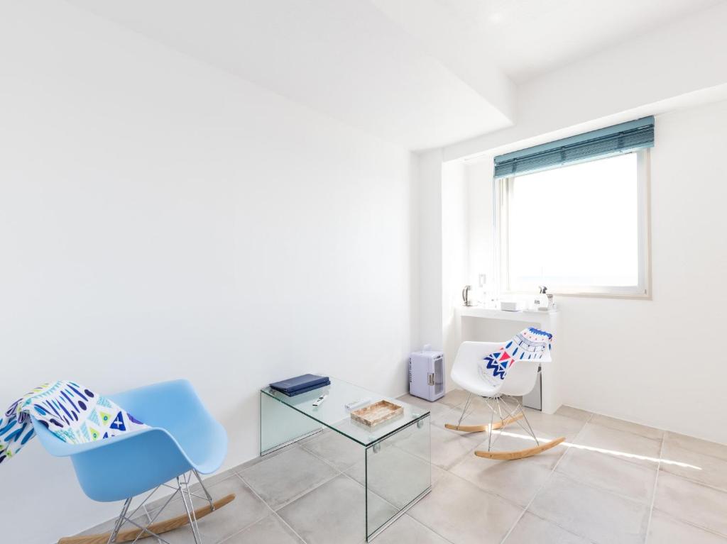 a living room with two chairs and a glass table at Mykonos Resort Miura / Vacation STAY 62208 in Yokosuka
