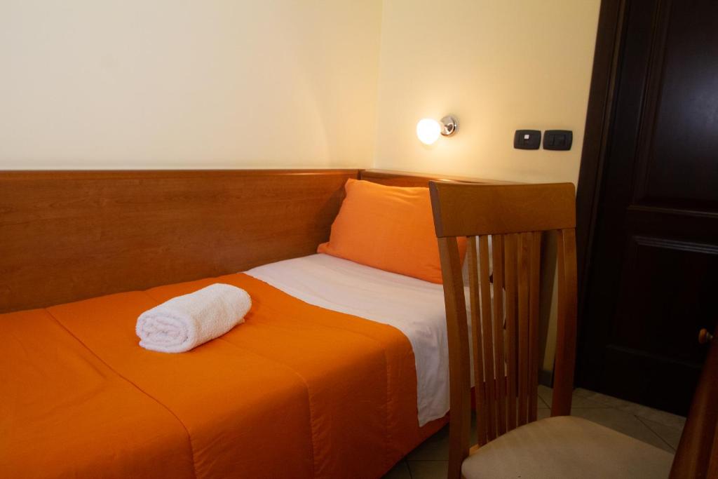 Postel nebo postele na pokoji v ubytování Hotel Merlino