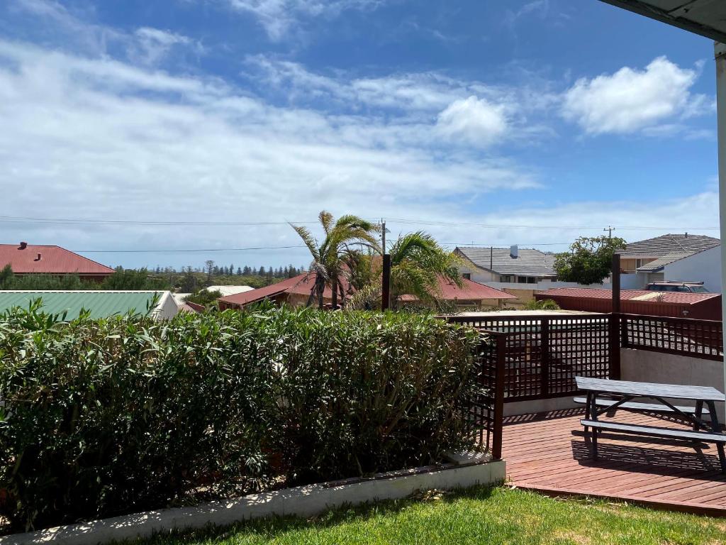 a bench sitting on a deck next to a fence at Waldeck Heights in Geraldton