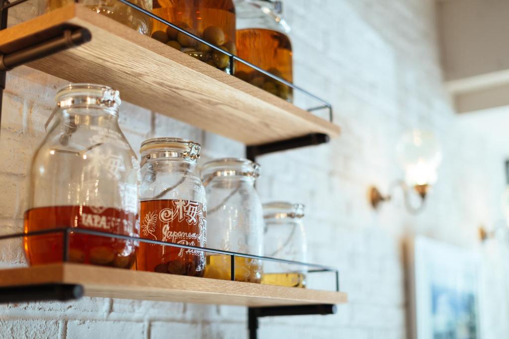 a group of glass bottles on shelves on a wall at Hotel Pacific Kanazawa in Kanazawa