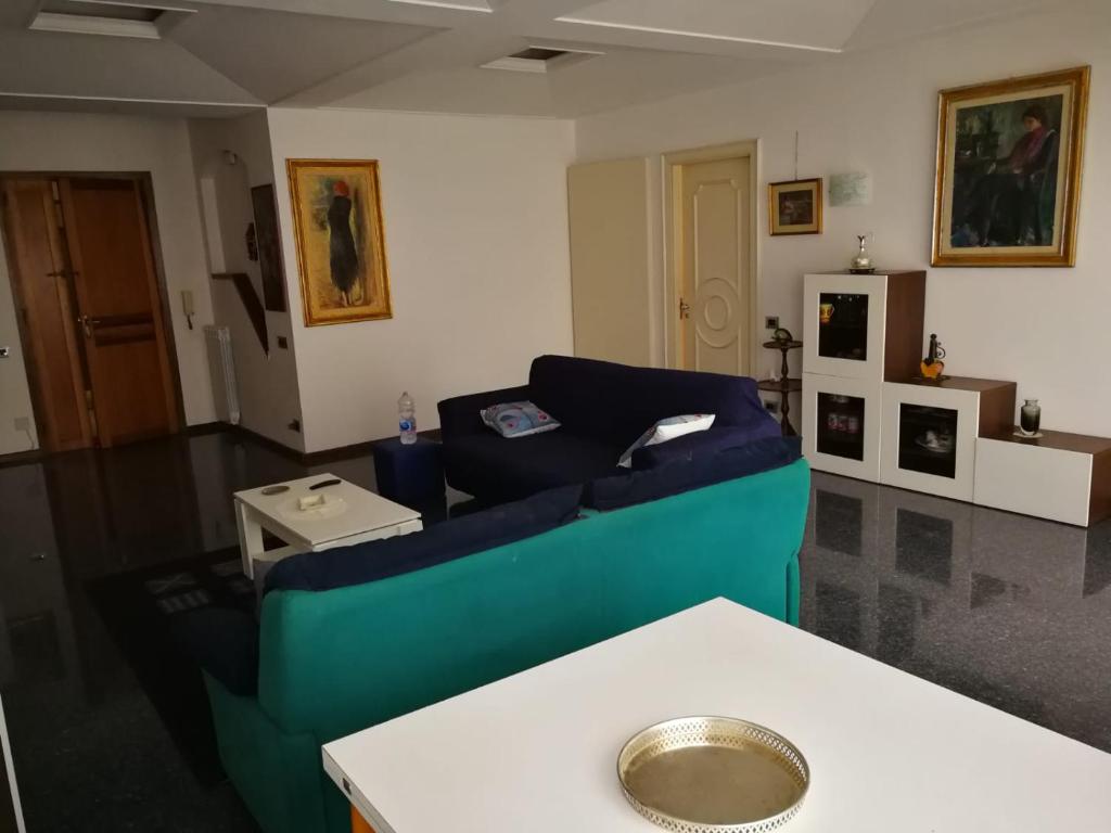 a living room with a blue couch and a table at A casa di marcello in Catanzaro