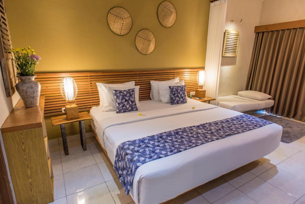 Postel nebo postele na pokoji v ubytování Pangkung Sari Bed and Breakfast