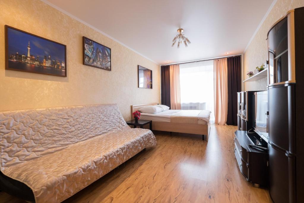 a hotel room with a bed and a television at ОК! Красноармейская, 151 in Tomsk