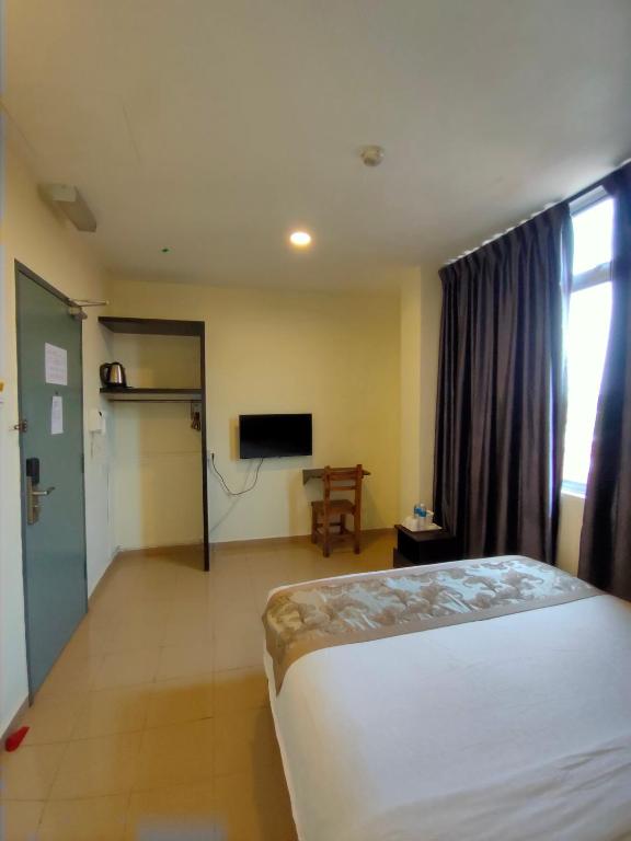 Postel nebo postele na pokoji v ubytování TIONG HUA HOTEL