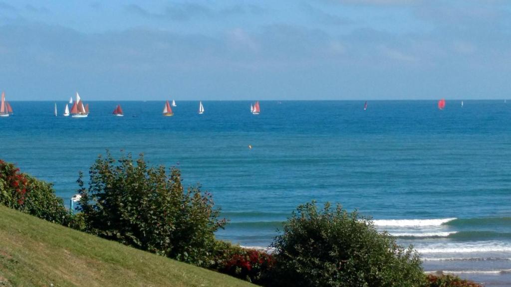 a view of the ocean with sailboats in the water at Vista Room with a Sea View in Paignton