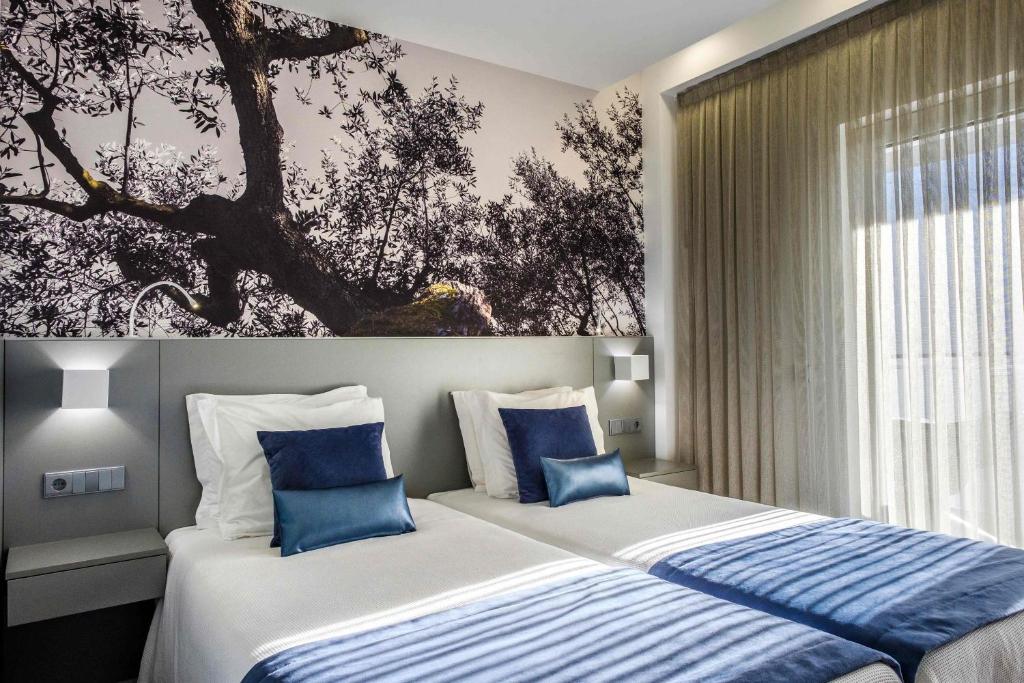 Tempat tidur dalam kamar di Serra d'Aire Boutique Hotel - SA Hotels