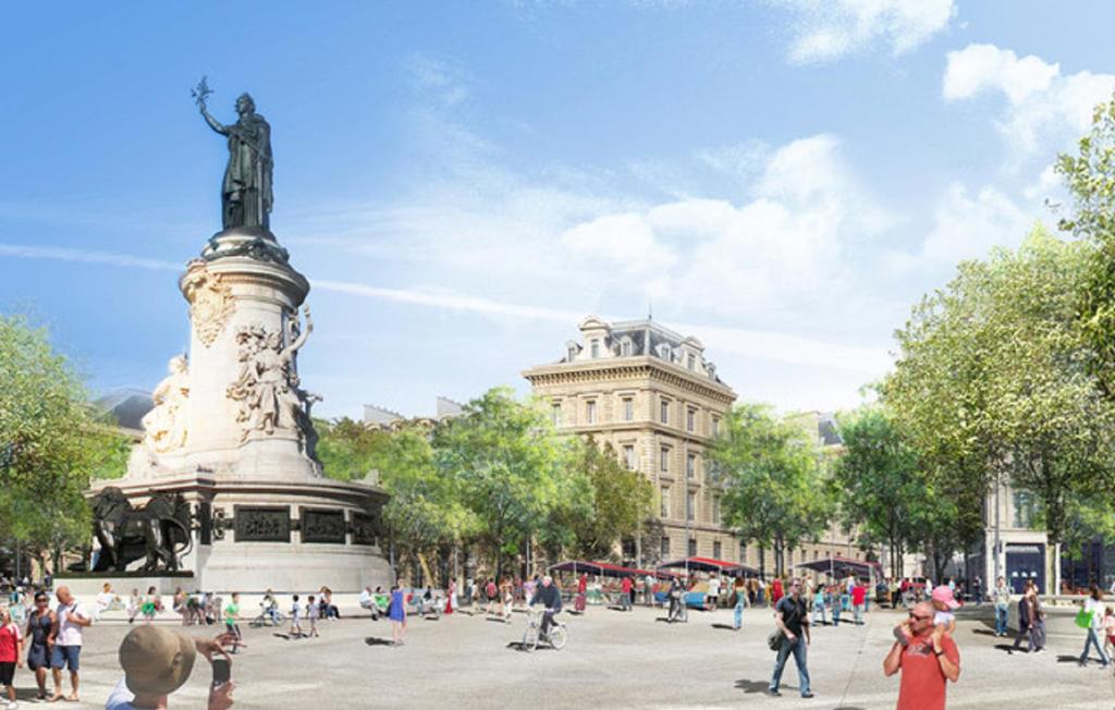 a statue in a plaza with people walking around it at 61- Big Luxury Parisian Flat 2DD in Paris