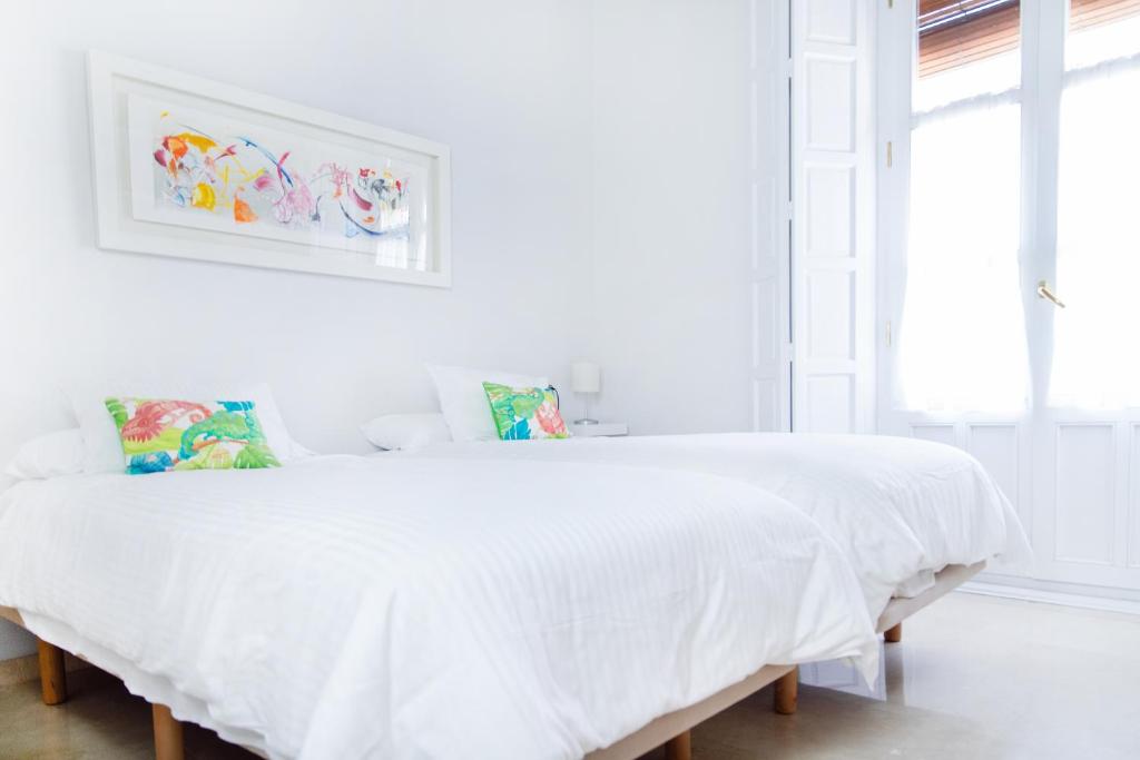 Posteľ alebo postele v izbe v ubytovaní Hispalis Casa Palacio Apartment