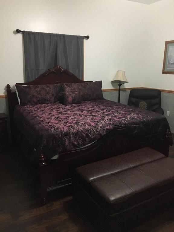 a bedroom with a bed with a purple comforter at Zion's Most Wanted Hotel in Hildale
