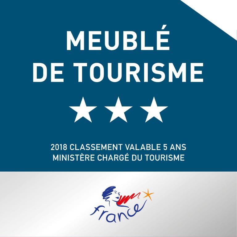 a sign that reads neville de toucourse with white stars at Studio 237 Port Camargue, Piscine, Climatisation, 2 personnes in Le Grau-du-Roi