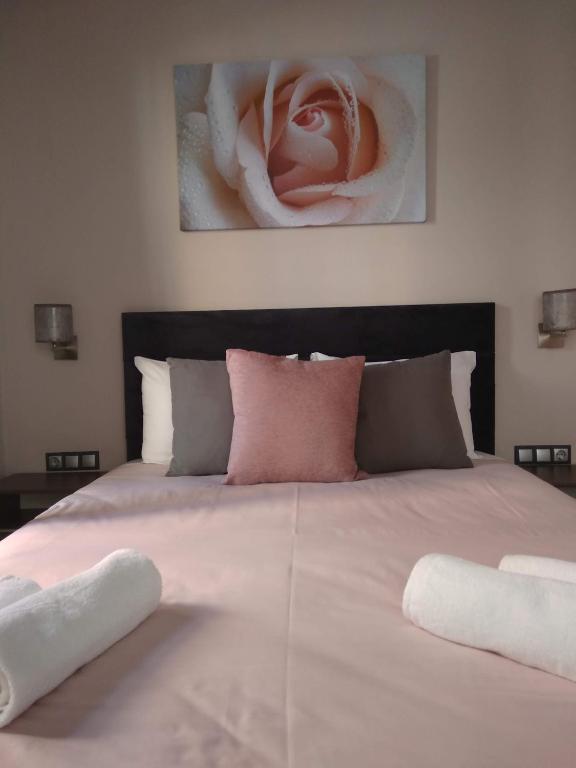uma cama grande com duas almofadas em cima em Marina's Luxury Rooms em Nafplio