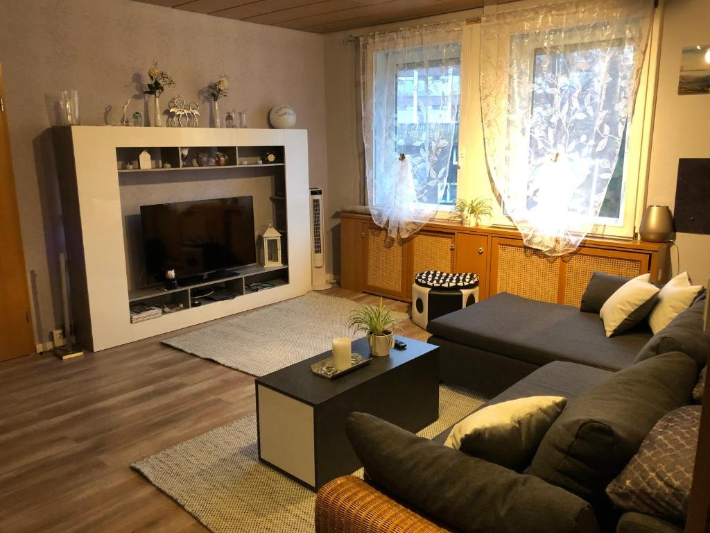 a living room with a couch and a television at Kristallkugel in Melsungen