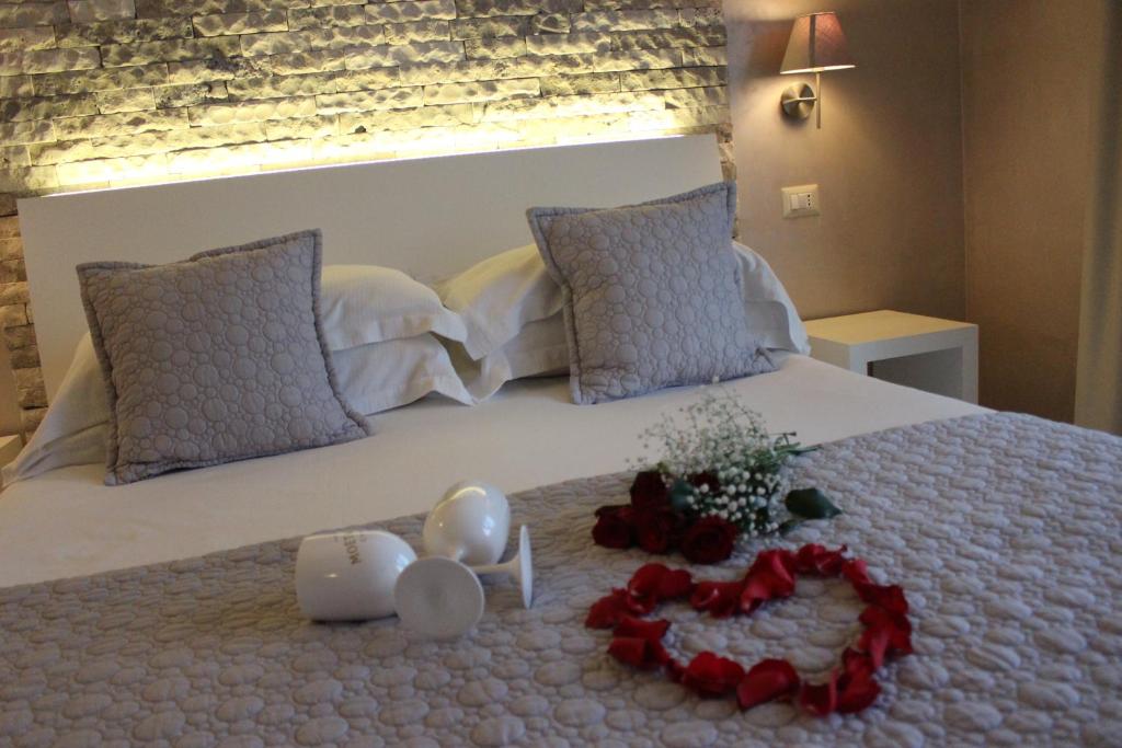 a bedroom with a bed with a flower arrangement on it at Borgo di Santa Barbara in Santa Domenica