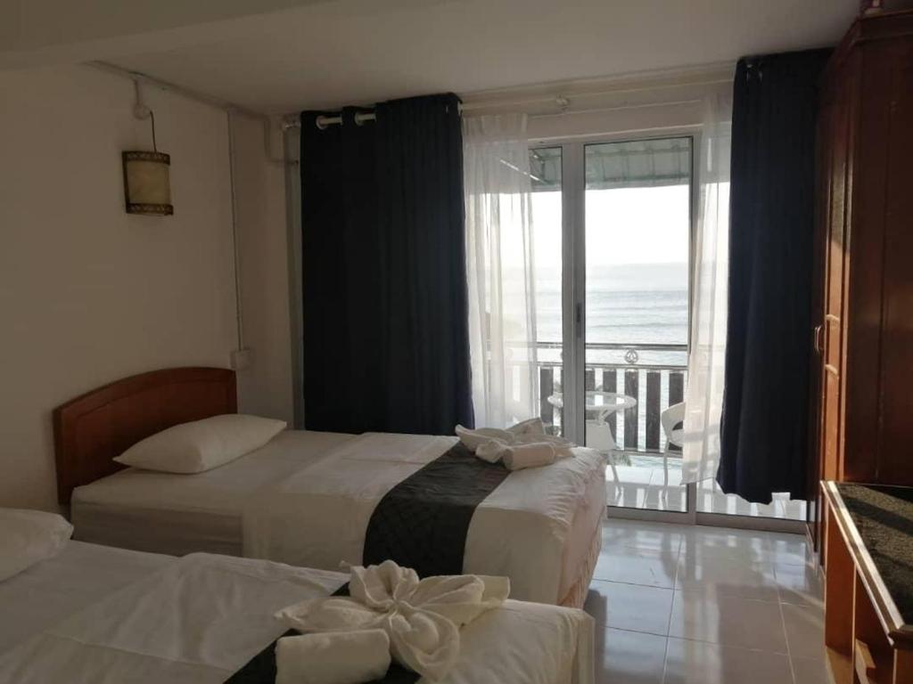 Postel nebo postele na pokoji v ubytování Perhentian Chomel Chalet