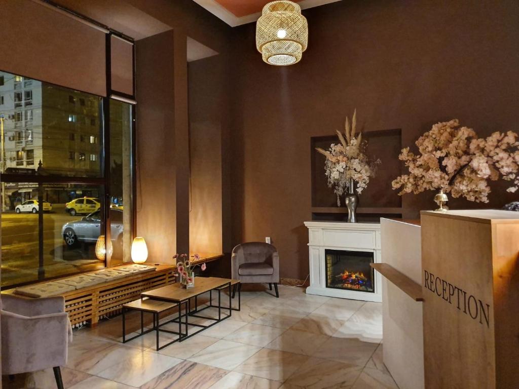a living room with a fireplace and a table at Hotel Continental City Center in Iaşi