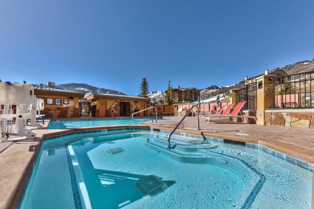 a large pool with a slide in a resort at Sundial Lodge 1 Bedroom by Canyons Village Rentals in Park City