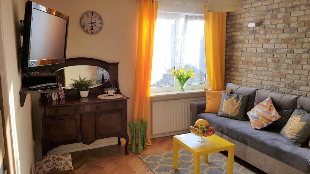 a living room with a blue couch and a mirror at Romantic Old City Gdansk in Gdańsk