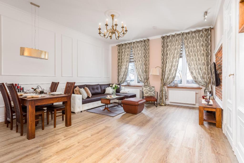 a living room with a table and a couch at Comfort Studio Central in Szczecin