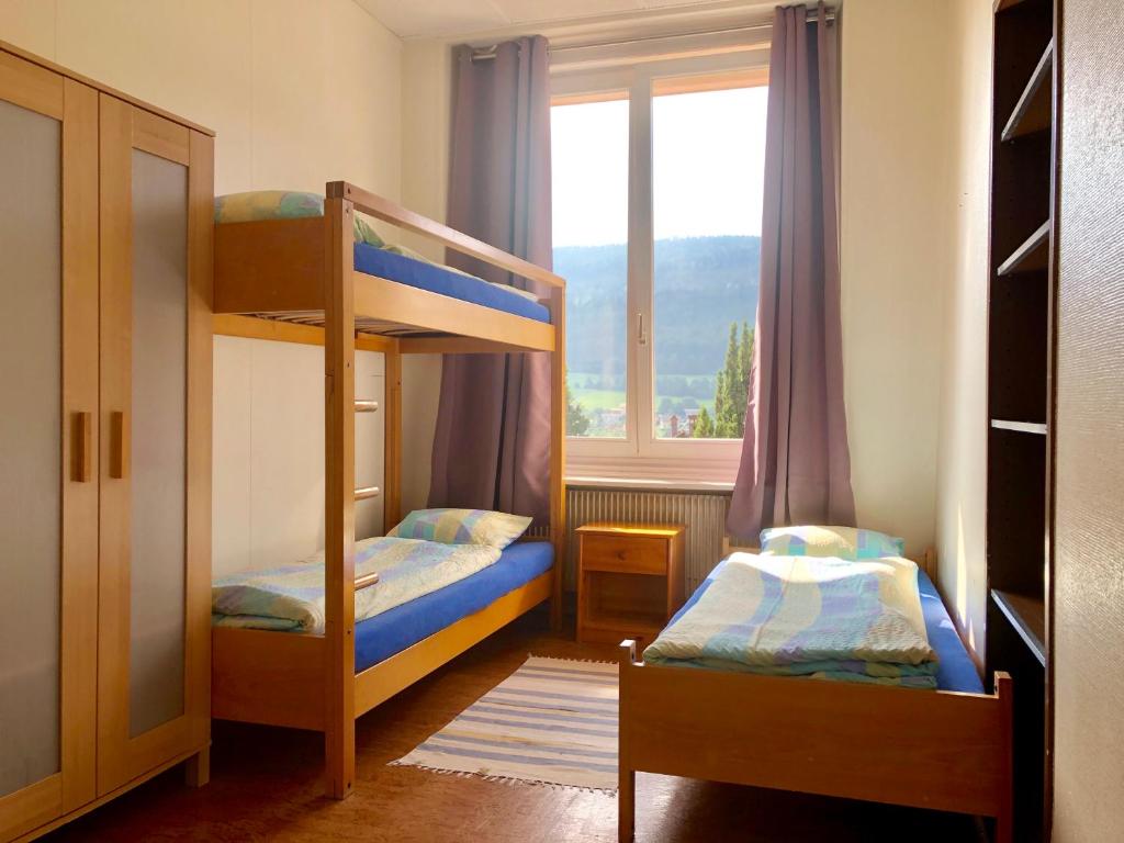 Letto o letti in una camera di Auberge Pour Tous