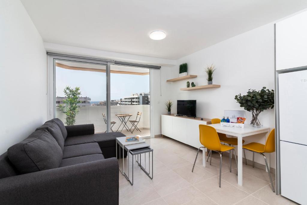 a living room with a couch and a table at HomeForGuest Modern and recently renovated apartment in Arona in Arona