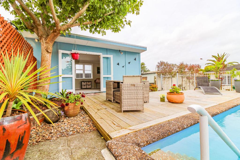 a backyard with a wooden deck and a house at STUDIO @ 91 in Whanganui