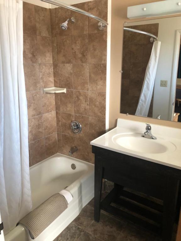 a bathroom with a sink and a tub and a shower at Meadowcliff Lodge Coleville in Coleville