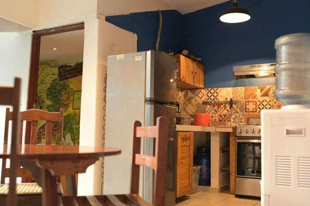 a kitchen with a refrigerator and a table in it at Casa Caballito in León