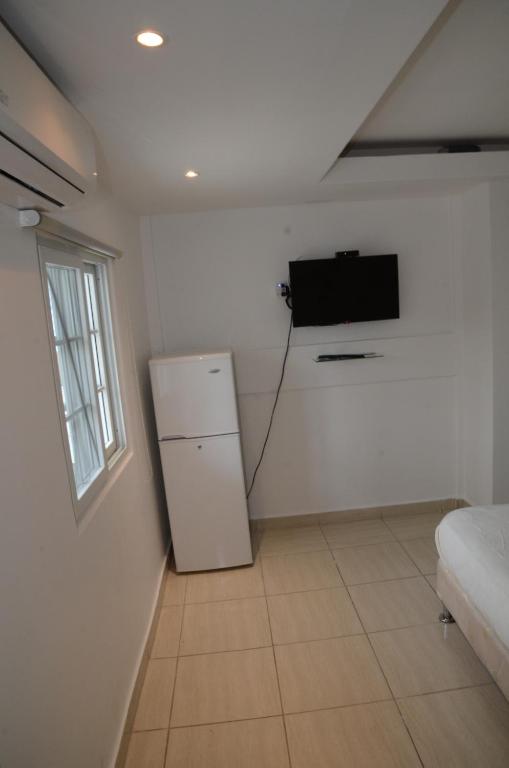 Postel nebo postele na pokoji v ubytování Hostal Familiar Carmencita