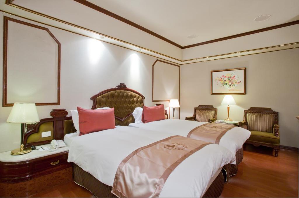 Voodi või voodid majutusasutuse Charming City Songshan Hotel toas