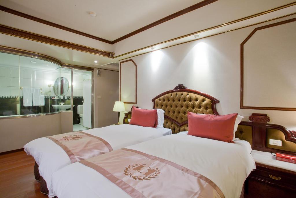Voodi või voodid majutusasutuse Charming City Songshan Hotel toas