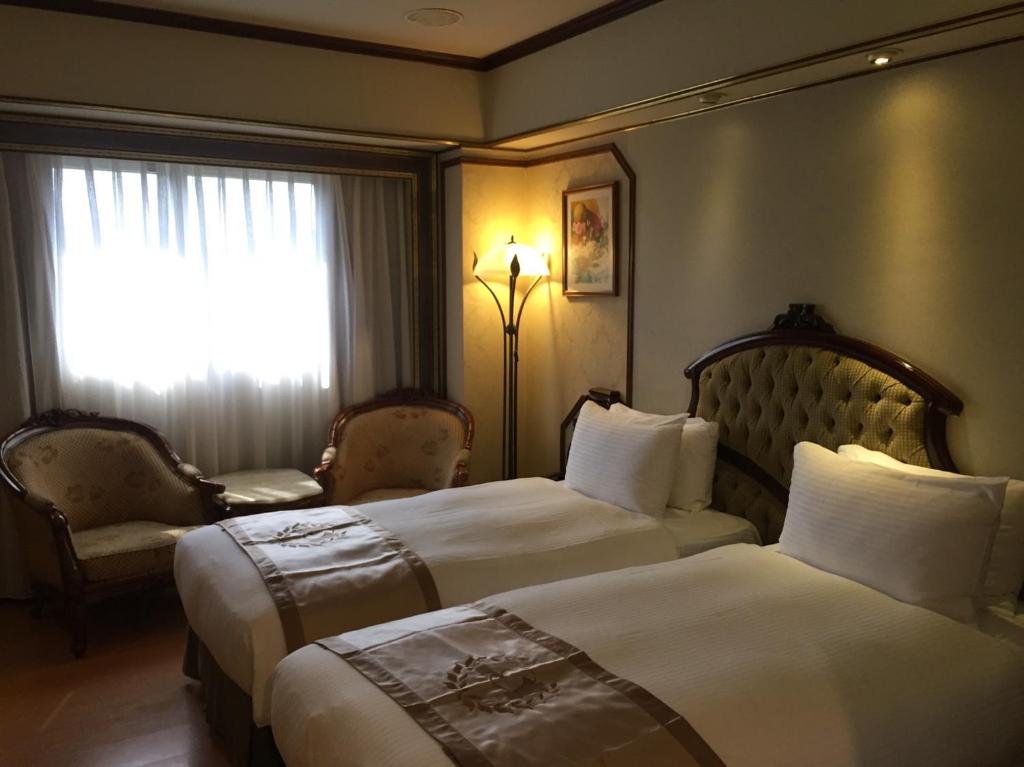 Voodi või voodid majutusasutuse Charming City Songshan Hotel toas