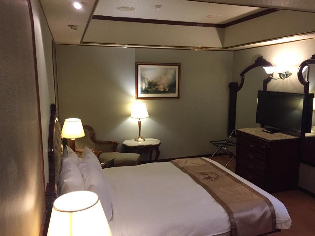 Voodi või voodid majutusasutuse Charming City Songshan Hotel toas